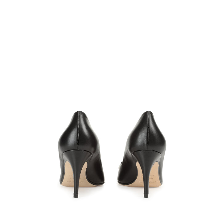 Back of sr1 black pointed mid-heel pump with silver logo-plate
